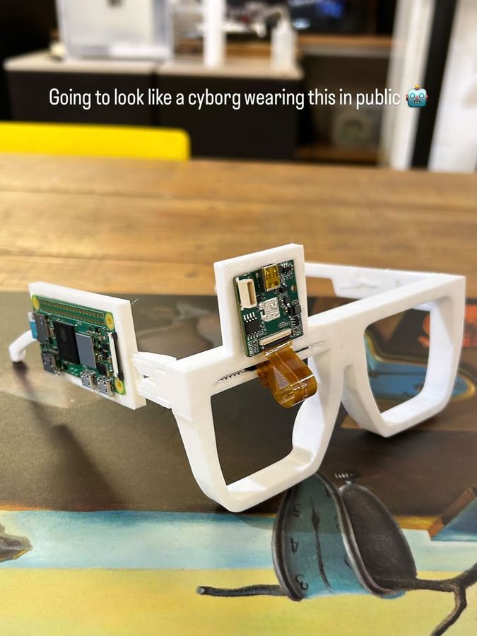 White 3D printed prototype frame with a circuit board on one arm