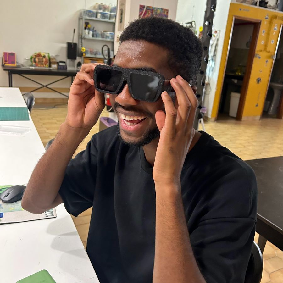 A man laughing as he puts the glasses on
