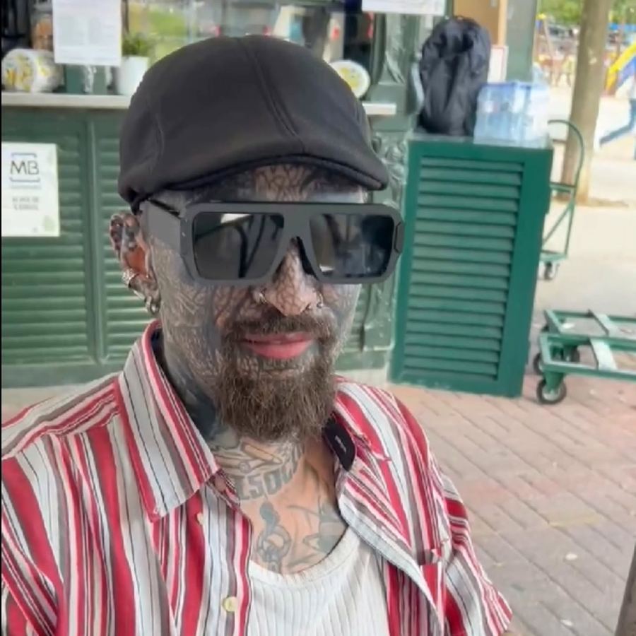 A man in a cap trying the glasses outside