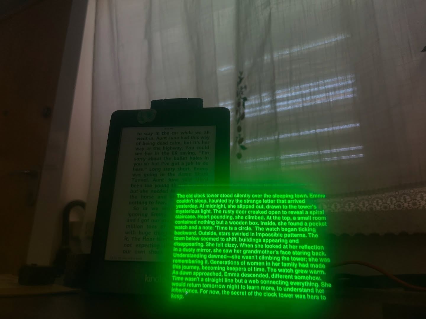 Green text from the glasses floating next to a Kindle showing the same novel